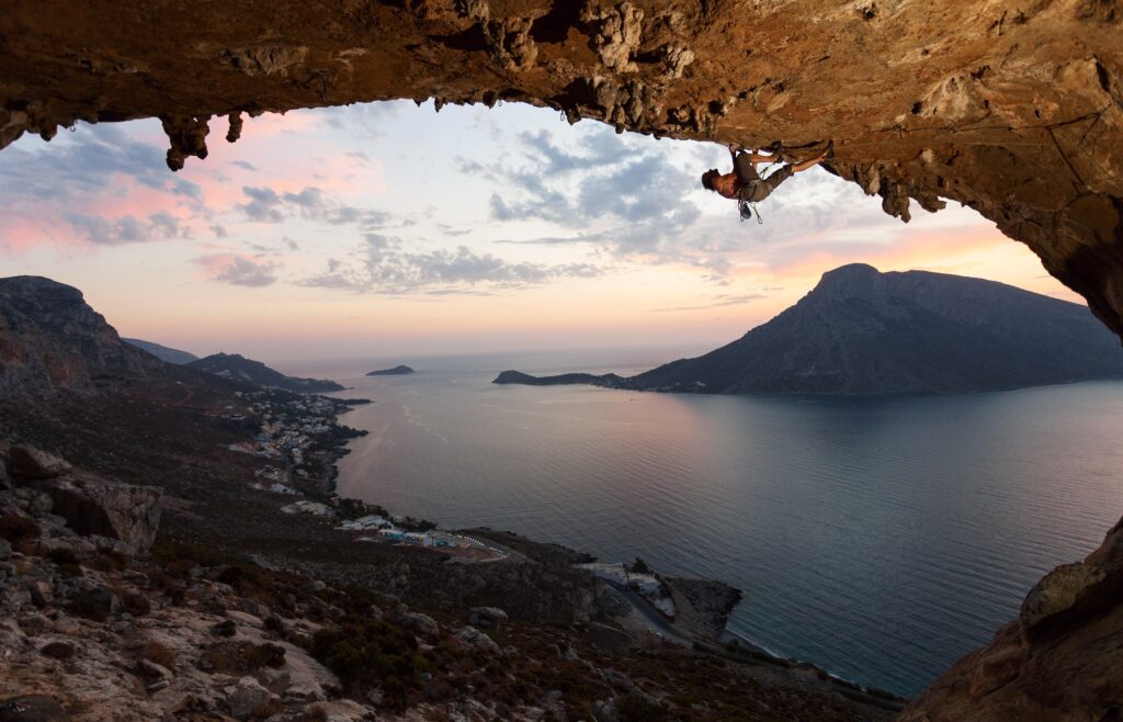Silhouette of a rock climber at sunset. Kalymnos Island, Greece.
